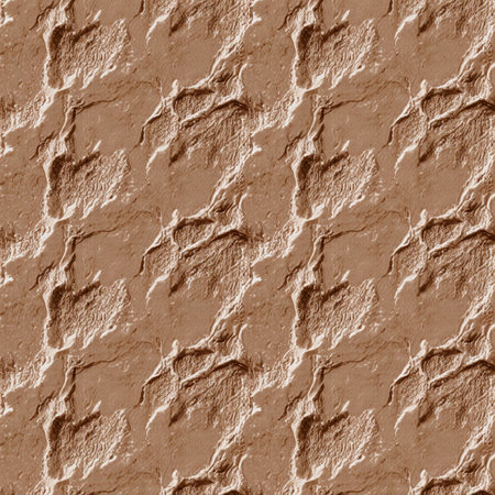 A warm brown surface displays an intricate texture, resembling natural clay or earth. Soft shadows create depth, enhancing its artistic appeal and inviting closer examination.の写真素材