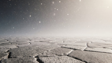 Snowflakes dance gently in the air as they settle on a vast, cracked surface in a remote, icy environment. The scene is serene and evokes a sense of tranquility and isolation.の写真素材