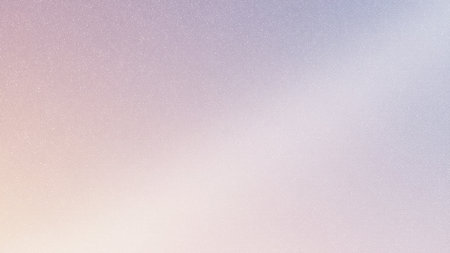 The sun sets softly, painting the sky with shades of pink and purple. A calm body of water reflects the colorful hues, creating a serene and peaceful atmosphere to enjoy.の写真素材