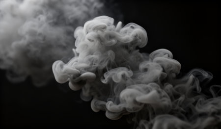 Delicate tendrils of smoke swirl and twist, creating an ethereal atmosphere. The dark background enhances the fluid motion, evoking a sense of calm and mystery in this captivating moment.の写真素材
