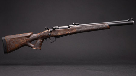 This stunning rifle showcases intricate woodwork and metal details, symbolizing skillful...