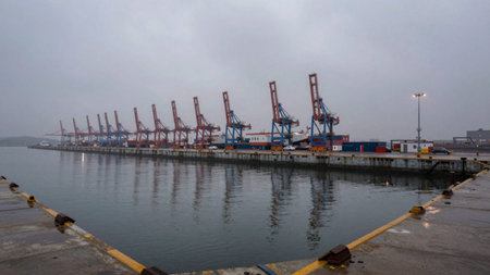 Harbor on a foggy day, in the foreground, a large body of water stretches out.