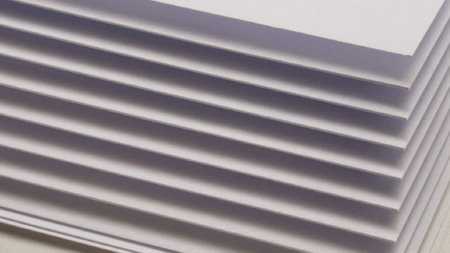 Of a stack of folded white paper, arranged in a neat and orderly fashion. The.