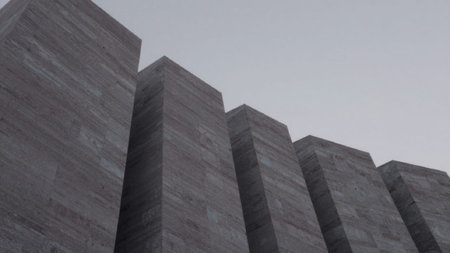 Of tall, rectangular concrete blocks arranged in a vertical line against a gray sky. The.