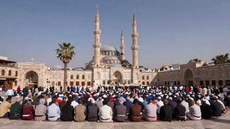 Group of people gathered in a public square in front of the Blue Mosque in Istanbul, Turkey, the...