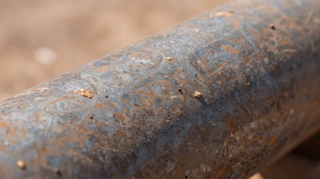 Of a rusty metal surface, likely part of a construction site, the metal appears to be aged and...