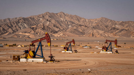 Barren landscape with a vast expanse of sandstone mountains in the background, the mountains are dominated by varying shades of beige and brown, creating a rugged, mountainous appearance. In the foreground, there are several large,の写真素材