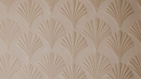 Of a beige, textured surface with a repeating, fan-like pattern. The pattern is made up of thin,...