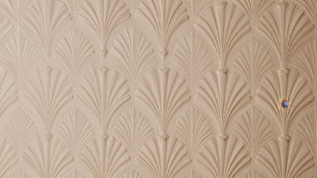 Of a textured surface with a repeating pattern. The surface appears to be made of a light beige...