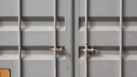 Of a close-up view of a gray metal container, likely used for storage or transportation purposes,...