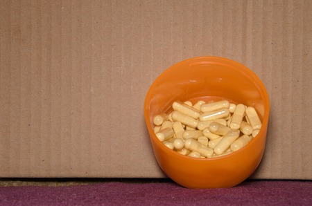 Natural organic herb vitamin capsule on the floorの写真素材