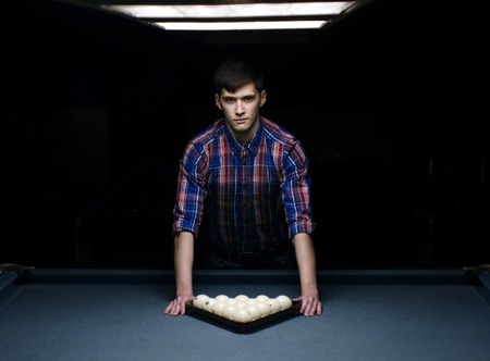 man in shirt prepare for start game of billiard with triangleの写真素材
