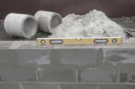 new beautyfull yellow level for building on the cinderblocks background. Process of building.