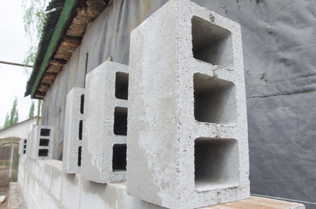 many neatly folded gray cinder blocks background closeup.