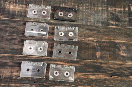Old audio cassettes on wooden background. music abstractの写真素材