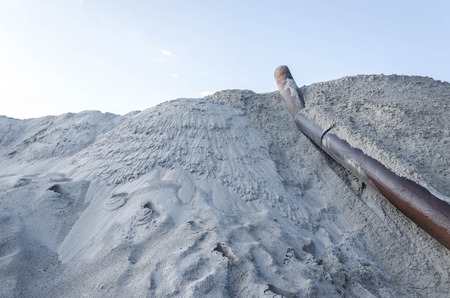 exavation machine excavator at earthmoving work in sand quarry. Extraction of sand from a sand pit. Iron technological constructions.の写真素材