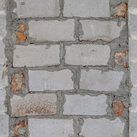 Bricked up door and cinder blocks brick wall texture. Abandoned house exterior