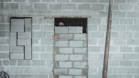 Bricked up door and cinder blocks brick wall texture. Abandoned house exteriorの写真素材