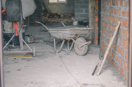 Mason bricklaying background with level, hammer and clay brick blocksの写真素材