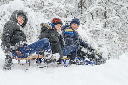 Ivano-Frankivsk, 13 november 2016. Winter fun, snow, happy children sledding at winter timeのeditorial素材