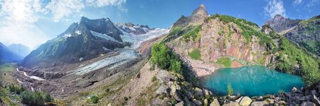Panoramic view of the mountain peaks, glacier and lake. Caucasus Mountains, Dombay.の写真素材