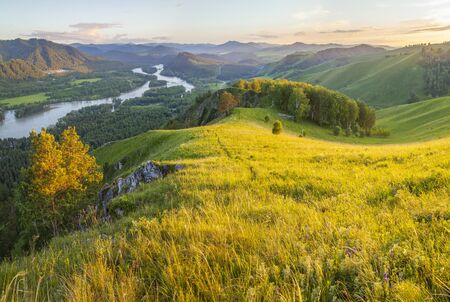 Tourism in Altay, Russia. View of the valley and the Katun River from the mountain. Spring panoramic view. Evening light.の写真素材