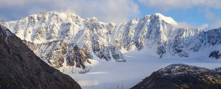 Snow-capped mountain peaks in the morning light. Traveling in the mountains, climbing.