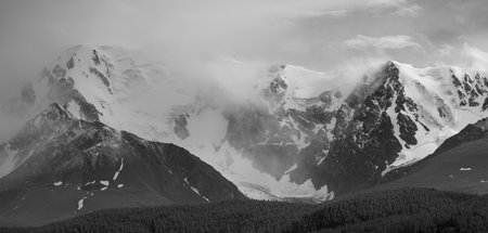Black and white landscape. Snow capped mountain peaks. Traveling in the mountains, climbing.