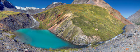 Small turquoise lake in the Altai mountains, scenic panoramic view. Summer sunny day. Traveling in the mountains, climbing.の写真素材