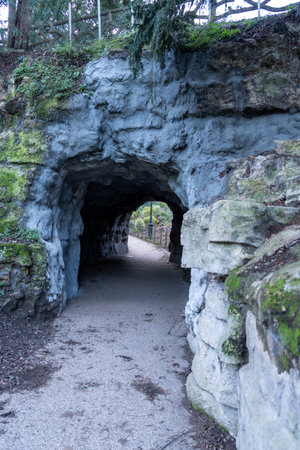 Exploring the picturesque pathways of Parc des Buttes-Chaumont in Paris on a calm, serene dayの写真素材
