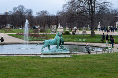 Visit to a tranquil park featuring a fountain and a sculpture of lions engaging with their environmentの写真素材