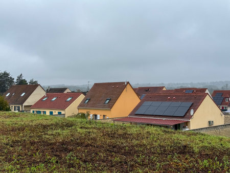 Residential houses with solar panels in a foggy landscape during early morning in a quiet neighborhoodの写真素材