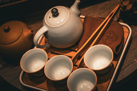 Traditional tea set arranged on a wooden tray for serving in an inviting settingの写真素材