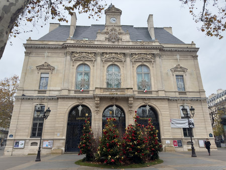 Beautifully decorated town hall with festive greenery and holiday spirit in Paris during winterの写真素材