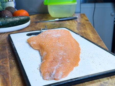 Preparing salmon fillet for a flavorful meal in a modern kitchenの写真素材
