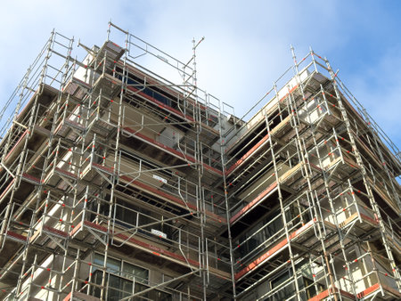 Construction site with scaffolding under a clear blue sky during the dayの写真素材