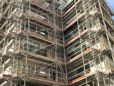 Scaffolding around a residential building under constructionの写真素材