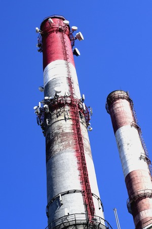 Smoking pipes of thermal power plant against blue skyの写真素材