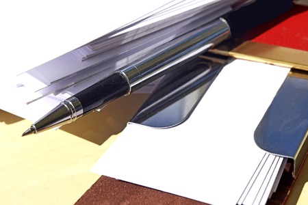 Blank business cards and pen on the tableの写真素材