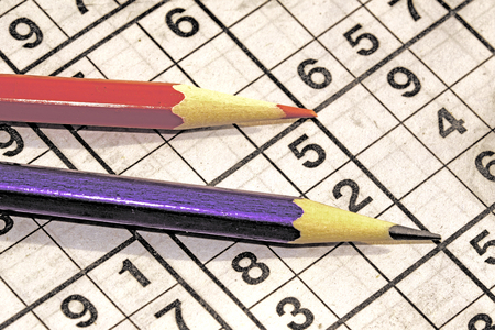 Game Sudoku and colored pencils on the tableの写真素材