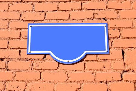 Pure blue plaque on a brick wallの写真素材