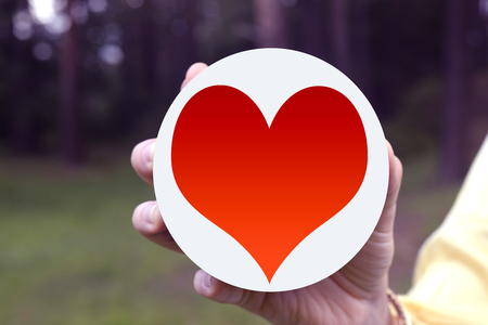 Red heart symbol in feminine handの写真素材