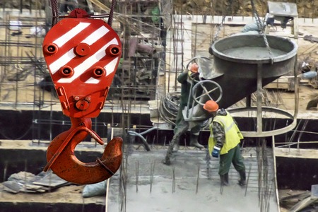 The hook of the elevating crane on a background of constructionの写真素材