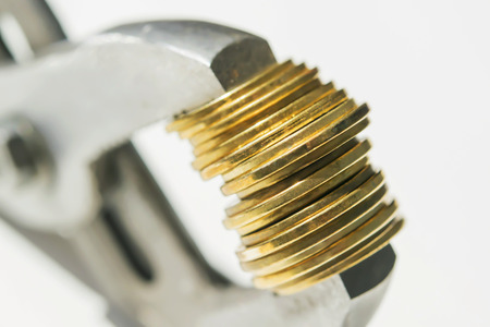 Wrenches and coins. The concept of financial reliability.の写真素材