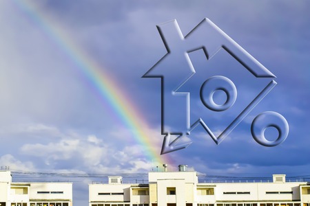 Rercent sign on the background of the house and rainbow .The concept of reducing property prices.の写真素材