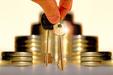 The keys to the apartment on the background of money. The concept of mortgage lending.の写真素材