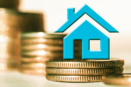 The symbol of real estate. The concept of price changes on the real estate marketの写真素材