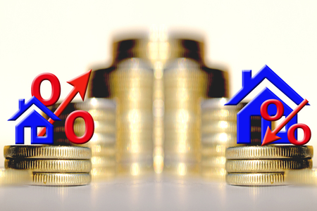 The percent symbol and real estate and on the background of bars coins. The concept of mortgage lendingの写真素材