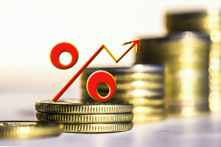 The percent symbol on the background of bars coins. The concept of mortgage lending.の写真素材