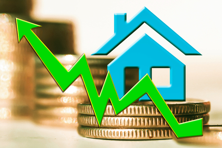 The graph of growth and a symbol of real estate on a background of money. The concept of changes in property prices.の写真素材